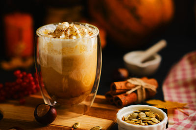 Pumpkin latte with whipped cream in a glasses