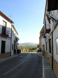 Road amidst buildings against sky in city