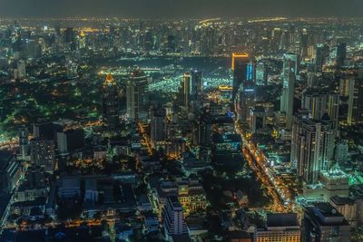 High angle view of illuminated buildings in city at night