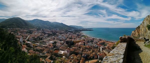 Panoramic view of sea and mountains against sky