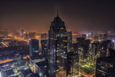 Aerial view of buildings in city at night