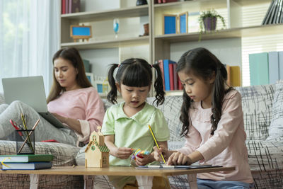 People looking at camera while sitting on table