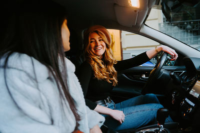 Young woman sitting in car