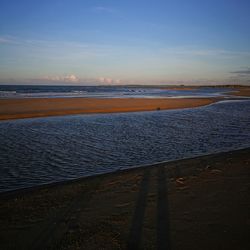 Scenic view of beach against sky during sunset