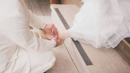 Rear view of couple holding hands