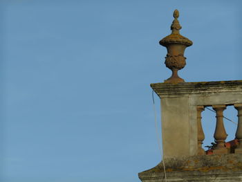 Low angle view of bell tower against blue sky