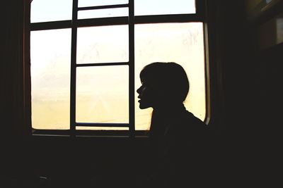 Woman looking through window