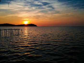 Scenic view of sea against romantic sky at sunset