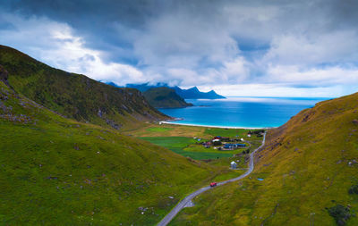 Scenic view of sea and mountains against sky