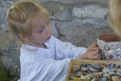 Side view of girl holding food