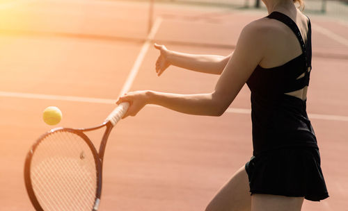 Midsection of woman playing tennis