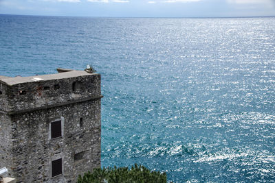 High angle view of building by sea against sky