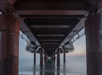 Bridge over sea against sky