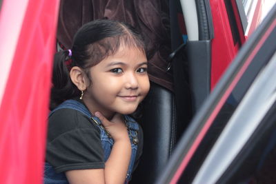 Girl smile at the red car