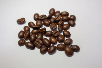 Close-up of coffee beans against white background