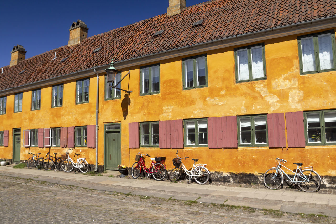 BICYCLES ON ROAD BY BUILDING