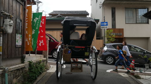 Pedicab on street by houses