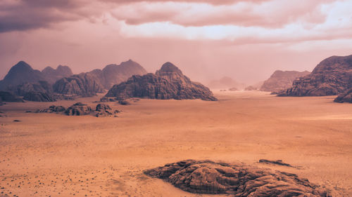 Storm and rain clouds over the desert landscape of wadi rum in jordan. panoramic shot