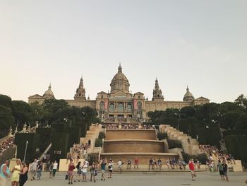 People at temple against clear sky