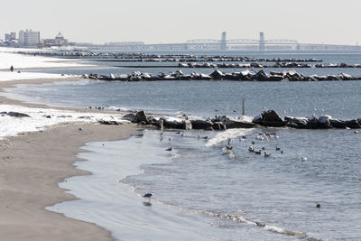 View of built structure by sea