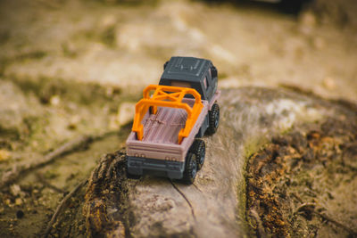 Close-up of toy car on rock