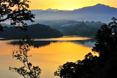 Scenic view of lake against sky during sunset