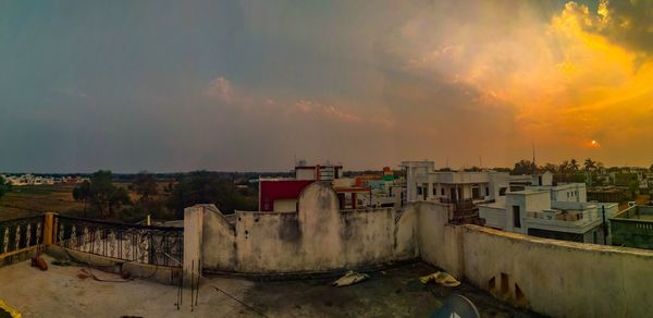 Buildings in city during sunset