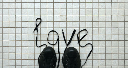 Low section of person standing on tiled floor