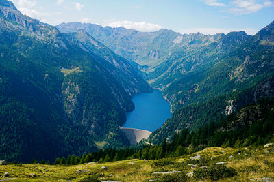 Scenic view of lake and mountains against sky