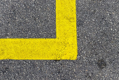 High angle view of yellow road sign on street