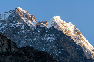 Scenic view of snowcapped mountains against clear sky