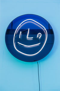 Low angle view of text on blue door