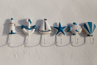 Clothes hanging against white wall