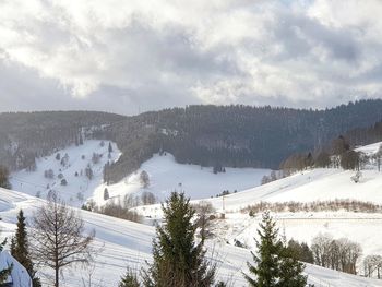 Scenic view of snow covered mountains against sky