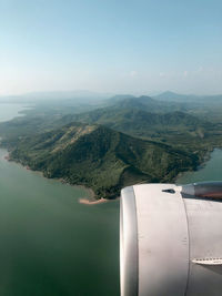 Aerial view of sea and mountains against sky