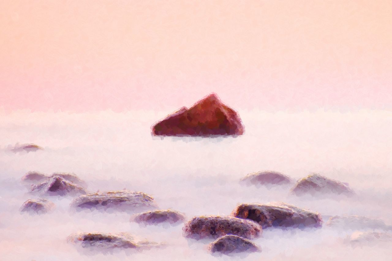 ROCKS ON SHORE AGAINST SKY DURING SUNSET