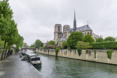 Back part of norte dame cathedral of paris by the seine on a cloudy day
