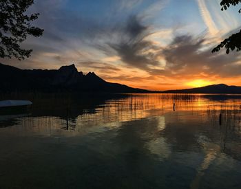 Panoramic view over lake against sky and mountains during sunset