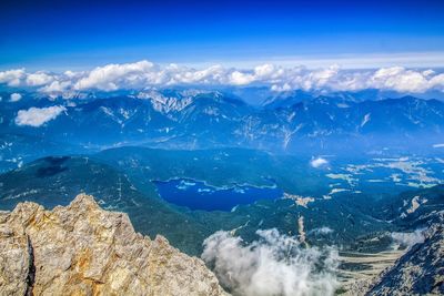 Aerial view of mountain range against cloudy sky