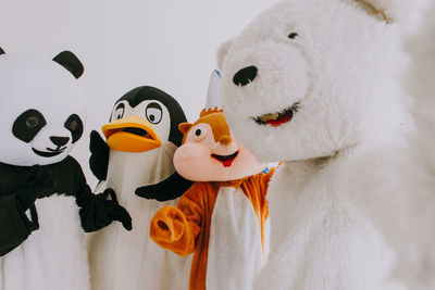 People wearing costume standing over white background