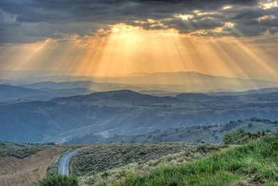 Sunlight sneaking through the clouds into the mountain