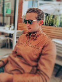 Young man wearing sunglasses standing outdoors