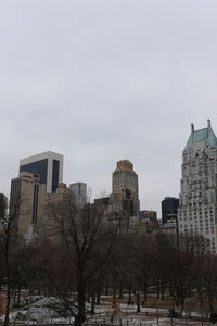 Low angle view of buildings against sky during winter