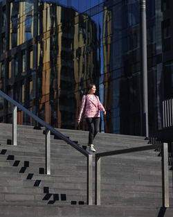 Low angle view of woman standing in city