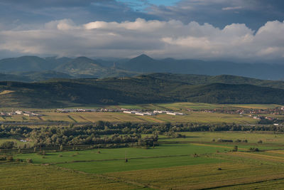 Scenic view of agricultural field and mountains against sky