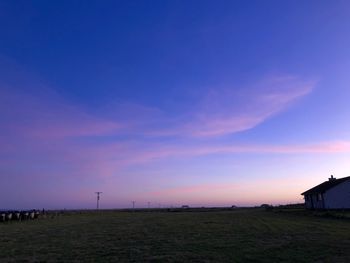 Scenic view of field against sky at sunset