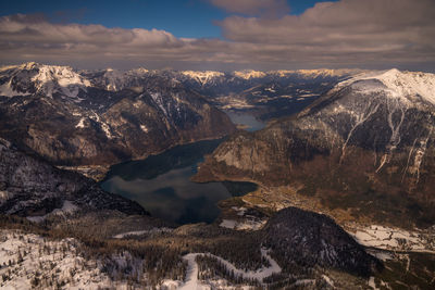 Aerial view of snowcapped mountains against sky during winter