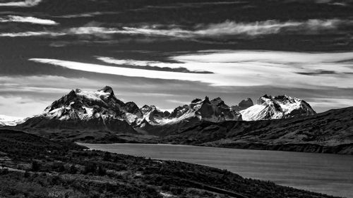 Scenic view of mountains against cloudy sky
