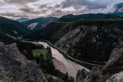 Scenic view of river amidst mountains against sky