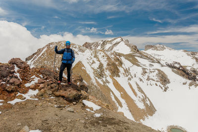 Rear view of man standing on mountain